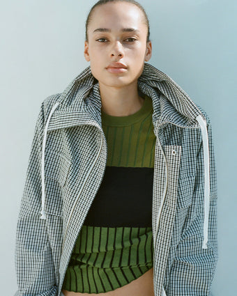 Cropped image of model wearing Nina Coat in Grid Crinkle Cotton layered over Peyton Paneled Sweater in Silk Cotton in olive multi