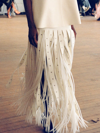 Model walking Proenza Schouler SS25 Runway show wearing Effe Skirt in Compact Viscose Knit in ivory