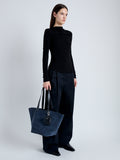 Image of model carrying Large Bedford Tote in Suede in navy/black