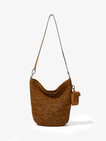 Front image of Raffia Spring Bucket Bag in HONEY with strap extended