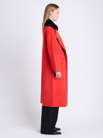 Side image of model wearing Emma Coat In Brushed Double Face Wool in vermillion melange