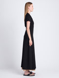 Side full length image of model wearing Noelle Dress in Jersey in BLACK