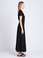 Side full length image of model wearing Noelle Dress in Jersey in BLACK