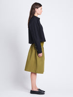 Side image of model wearing Olive Skirt in Peached Poplin in OLIVE