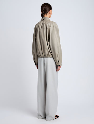Proenza Schouler Back full length image of model wearing Beck Bomber in Lightweight Nappa in Granite
