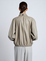 Proenza Schouler Detail image of model wearing Beck Bomber in Lightweight Nappa in Granite