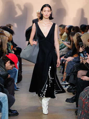 Model in Black Wool Felt Dress, Black Embroidered Velvet Dress, Cream Cone Over The Knee Boots, and Slate Felt XL PS1 Tote