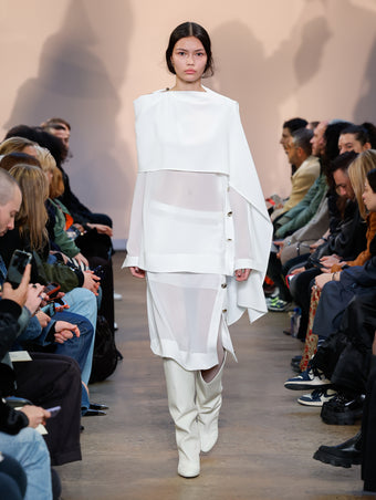 Model in Ivory Technical Chiffon Top, Ivory Technical Chiffon Skirt, and Cream Cone Boots