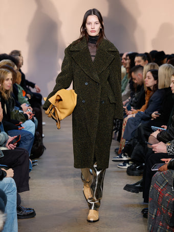 Model in Fawn Melange Wool Boucle Coat, Black Viscose Gauze Knit Top, Pale Gold Metallic Leather Pant, Natural Bronco Ankle Boots, Ginger XL PS1 Tote, and Black Leather Gloves
