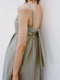 Cropped image of model's side standing against a white backdrop wearing the Claudine Dress in Tech Poplin in Sage