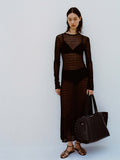 Image of model against white backdrop wearing the Miriam Dress in Crochet in Black