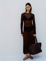 Image of model against white backdrop wearing the Miriam Dress in Crochet in Black