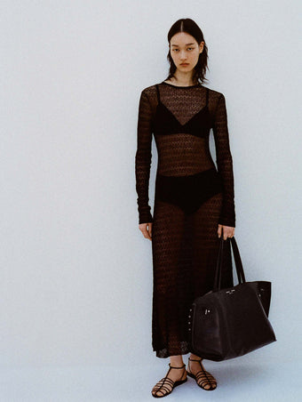 Image of model against white backdrop wearing the Miriam Dress in Crochet in Black