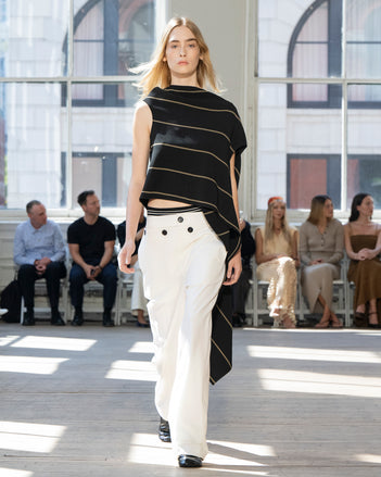 Image of model walking Proenza Schouler SS25 Runway wearing Sutton Top in Stripe Bi-Stretch Viscose in Black Multi and Oliver Pant in Wool Gabardine in Off White and Glove Shoe in BLACK