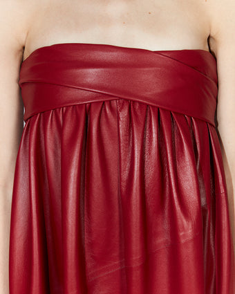 close crop of a red leather dress