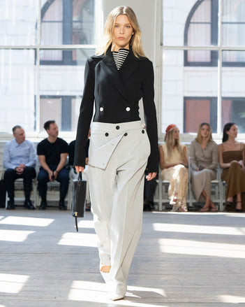 Image of model walking Proenza Schouler SS25 Runway wearing Marine Jacket in Bi-Stretch Viscose in Black and Prescott Top in Matte Viscose Crepe in Black Multi and Oliver Pant in Technical Herringbone  in Smoke and Silo Bag in Black Nappa  in BLACK and Slash Slingback Pump in WHITE