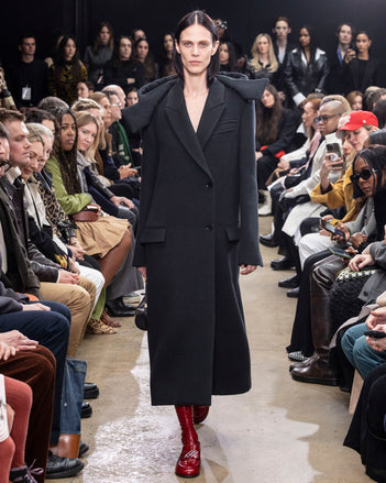 Model Walking in Proenza Schouler Fall Winter 2024 Runway Show Wearing Reed Coat in Charcoal Brushed Wool, Silo Bag in Black Nappa, and  Monogram Loafers in Rosewood Shiny Eel