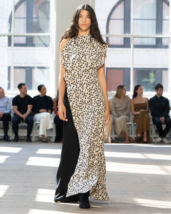 Image of model walking Proenza Schouler SS25 Runway wearing Devyn Dress in Printed Silk Viscose in Sand Multi and Slash Tie Sandal in BLACK