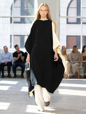Image of model walking Proenza Schouler SS25 Runway wearing Emin Dress in Viscose Cady in Black Multi and Weyes Pant in Matte Viscose Crepe in White and Silo Bag in Black Nappa  in BLACK and Tee Perforated Slingback  in BLACK
