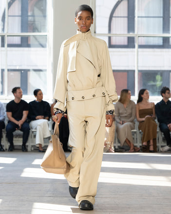 Image of model walking Proenza Schouler SS25 Runway wearing Adrien Jacket in Fluid Viscose in Sand and Emmeline Shirt in Printed Silk Viscose in Black Multi and Darya Pant in Fluid Viscose in Sand and Days Carryall in Cumin Smooth Calf in CUMIN and Chelsea Boot in Black