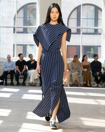 Image of model walking Proenza Schouler SS25 Runway wearing Selene Dress in Plaid Bi-Stretch Viscose in Cobalt Multi and Track Sneaker in BLACK/WHITE