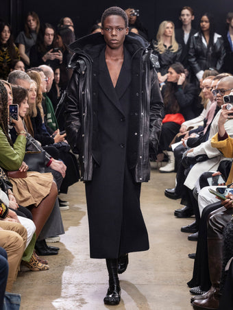 Model Walking in Proenza Schouler Fall Winter 2024 Runway Show Wearing Wilder Coat in Black Leather, Reed Coat in Black Brushed Wool, and Park Loafers in Black Slick Nappa