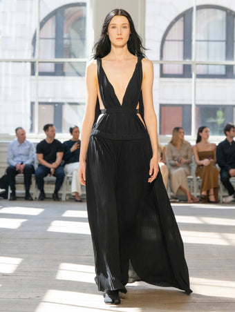 Image of model walking Proenza Schouler SS25 Runway wearing Serra Dress in Matte Jersey in Black and Slash Tie Sandal in BLACK