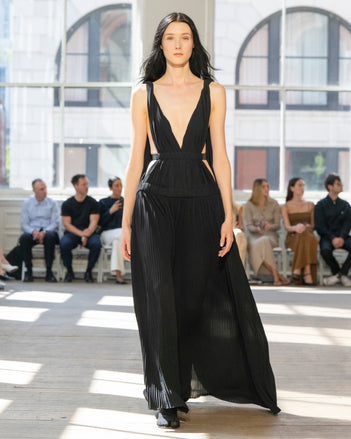 Image of model walking Proenza Schouler SS25 Runway wearing Serra Dress in Matte Jersey in Black and Slash Tie Sandal in BLACK
