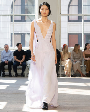 Image of model walking Proenza Schouler SS25 Runway wearing Serra Dress in Matte Jersey in Lilac and Slash Tie Sandal in BLACK