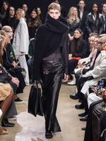 Image of model walking Proenza Schouler Fall Winter 2024 Runway wearing Adriana Skirt in Paper Leather in black