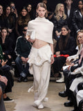 Image of model walking Proenza Schouler Fall Winter 2024 Runway wearing Shawl in Textured Knits in ivory
