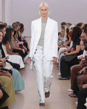 Model Walking Proenza Schouler SS24 Runway In Kiki Tank In White Cotton Mesh, Dara Top In Smoke Technical Nylon Jersey, Ellsworth Jean In Bleached Denim, Sandis Jacket In White Cotton Viscose Suiting, Flip Shoulder  Bag In Optic White Silk Satin, Tee Toe Ring Sandals In Black + Cream Nappa Lux