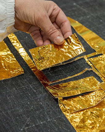 metallic gold foil being put together for gold drawstring bag