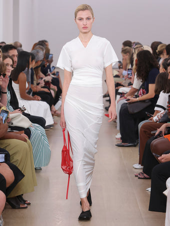 Model Walking Proenza Schouler SS24 Runway In Sidney Dress In White Silk Viscose, Net Sling Bag In Optic Red Tulle, Soft Square Slippers In Black Silk Satin