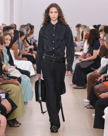 Model Walking Proenza Schouler SS24 Runway In Olympia Dress In Black Washed Habotai, Otis Pant In Black Viscose Wool Suiting, City Messenger Bag In Black Nappa Leather, Monogram Loafers In Black Nappa