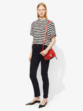 Model carrying PS1+ Mini Crossbody Zip Bag in cardinal