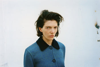 A wide portrait of a model in the Proenza Schouler FW26 Campaign wearing the Gaelle Jacket
