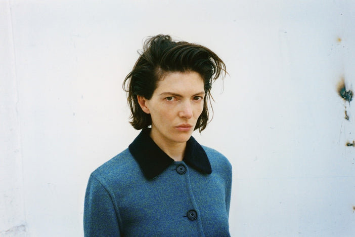 A wide portrait of a model in the Proenza Schouler FW26 Campaign wearing the Gaelle Jacket