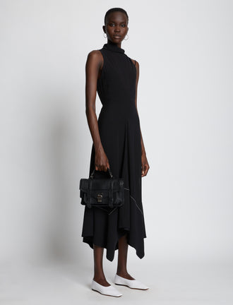 Image of model carrying PS1 Tiny Bag in black