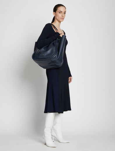 Image of model carrying XL Ruched Tote in DARK NAVY