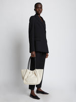 Image of model holding Large Ruched Tote in CLAY