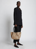Image of model holding Large Ruched Tote in LIGHT TAUPE