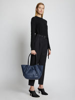 Image of model holding Large Ruched Tote in DARK NAVY