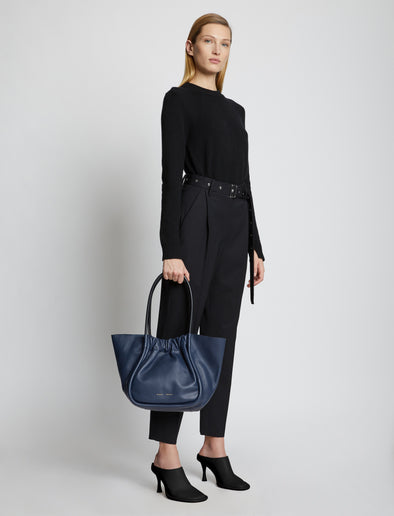 Image of model holding Large Ruched Tote in DARK NAVY