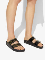 Proenza Schouler image of model wearing Birkenstock collaboration Arizona Slides in black with yellow contrast stitching