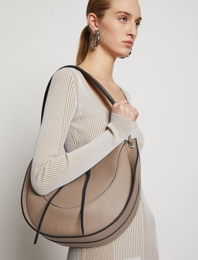 Image of model wearing Arch Shoulder Bag in LIGHT TAUPE.jpg