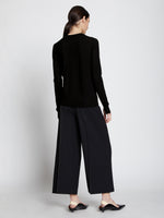 Back full length image of model wearing Eco Superfine Merino Sweater in BLACK