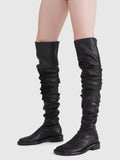 Image of model wearing ruched thigh-high boots in Black
