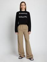 Front full length image of model wearing Logo Long Sleeve T-Shirt in BLACK