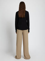 Back full length image of model wearing Logo Long Sleeve T-Shirt in BLACK